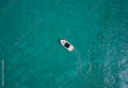White yacht on blue water top view