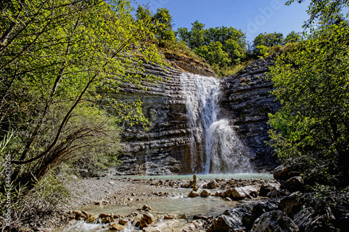 Low angle view of waterfall on eroded rock photo