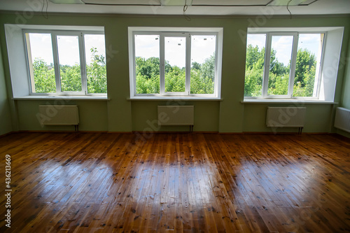 Empty room with large windows after renovation.