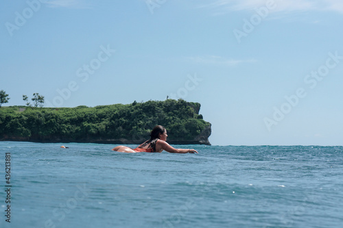 Young woman with beautiful body in swim suit surfer on surf board