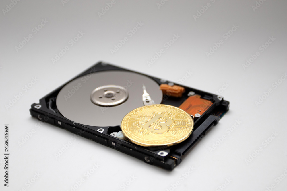 Coin of bitcoin with HDD. Cryptocurrency coin on HDD