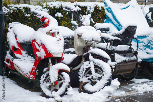 parking lot covered in snow,Motorcycle covered with snow.