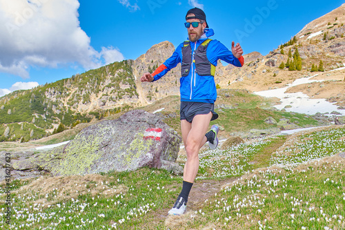 Downhill runner on reported mountain trail