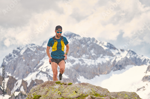 Trail Running athlete in the mountains on rocks