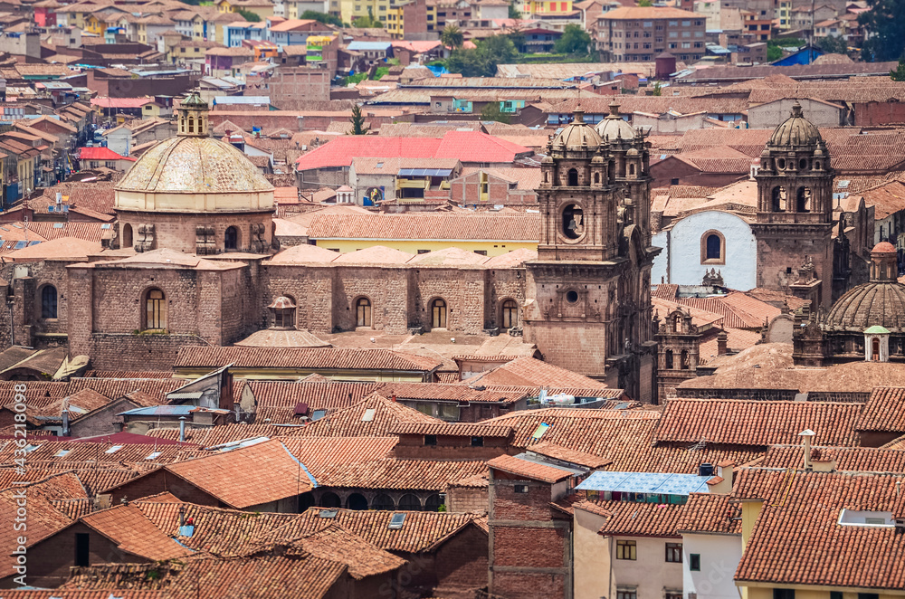 Aerial view of rooftops in Cusco city. Houses and churches from a fair away point. Peru, South America