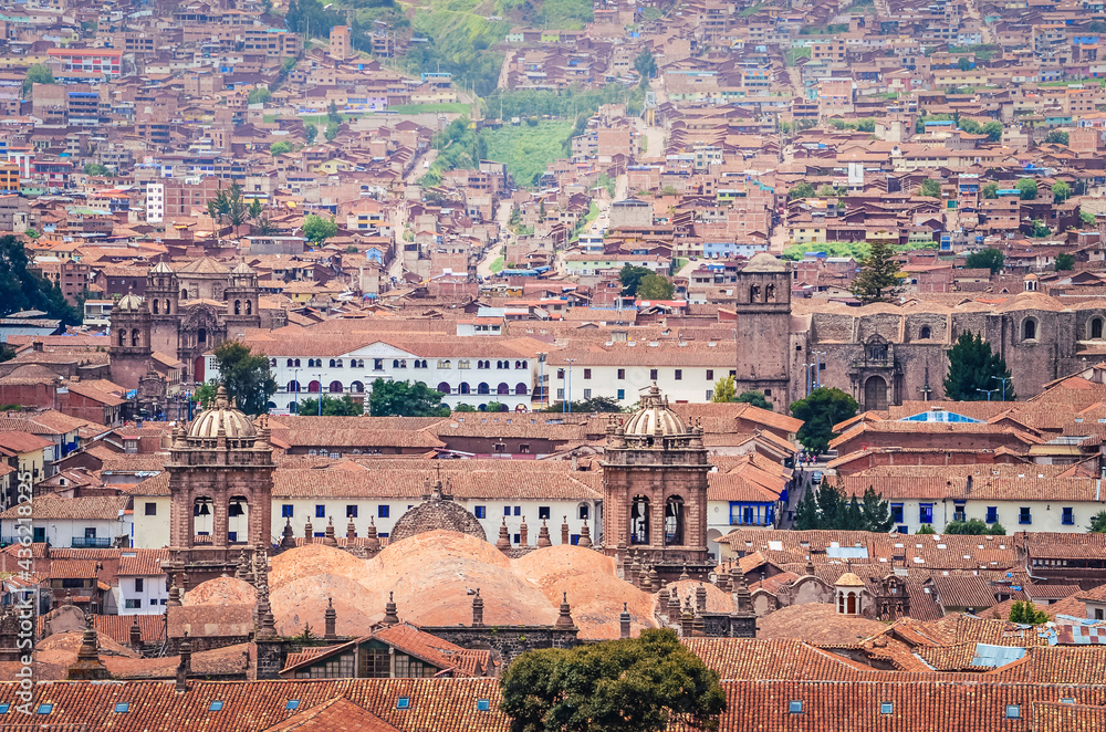 Aerial view of rooftops in Cusco city. Houses and churches from a fair away point. Peru, South America