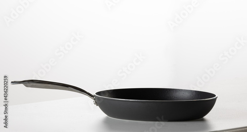 black frying pan on white counter