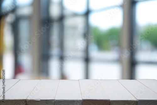 wood table on blur of cafe, coffee shop, bar, background - can used for display or montage your products