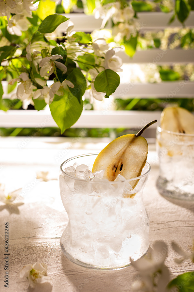 Glass of fresh iced lemonade in a summer garden