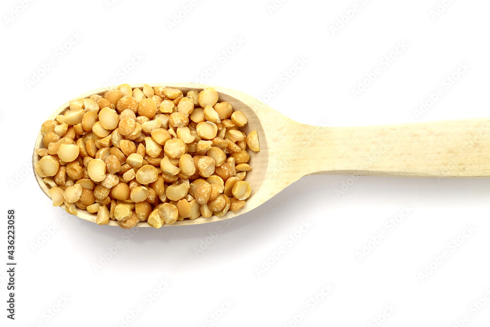 dried peas in a wooden spoon isolated on white background dried peas in a wooden spoon isolated on white background