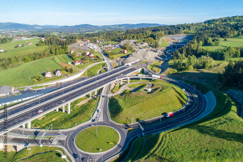 New highway in Poland on national road no 7, E77, called Zakopianka.  Overpass junction with a traffic circle, viaducts and slip roads. A tunnel under construction