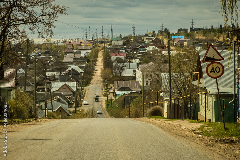 Fototapeta premium federal highway passes through a small provincial town with old wooden houses