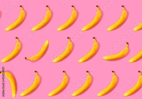 Ripe bananas on a pink background. Bananas pattern.