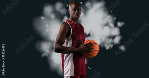 Composition of african american male basketball player holding ball with copy space