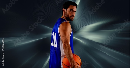 Composition of caucasian male basketball player holding ball with copy space