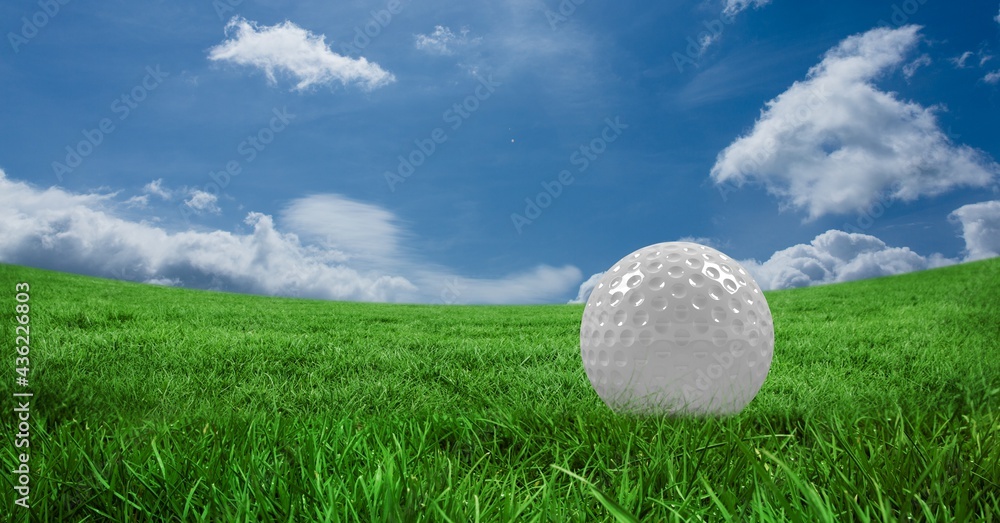 Composition of golf ball in grass, blue sky and copy space Composition of golf ball in grass, blue sky and copy space