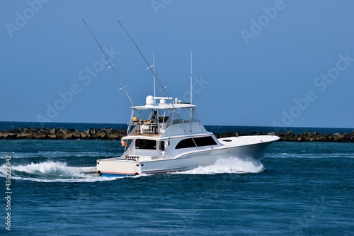 Fényképezés Luxury yacht cruising along the ocean inlet background
