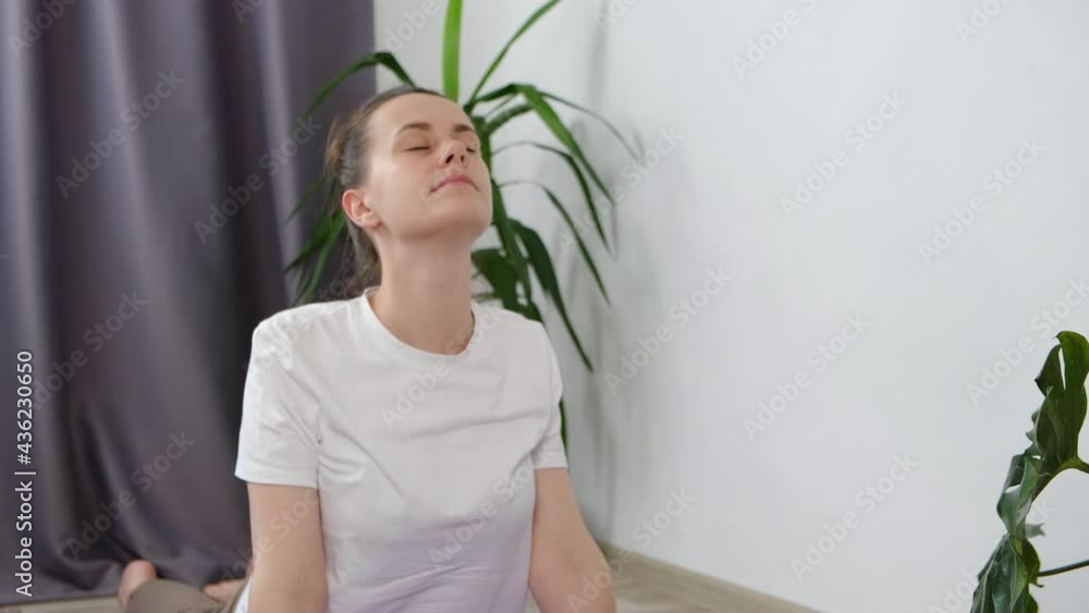 Online workout concept. Fit young woman doing yoga exercise, girl watching tv yoga class learning position with fitness tutorial on laptop computer stretching on mat at home, training body flexibility Online workout concept. Fit young woman doing yoga exercise, girl watching tv yoga class learning position with fitness tutorial on laptop computer stretching on mat at home, training body flexibility