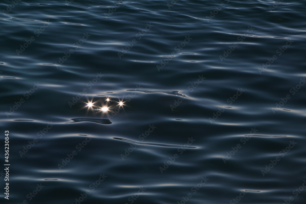 stars in a sea. Sun reflection on the water surface.