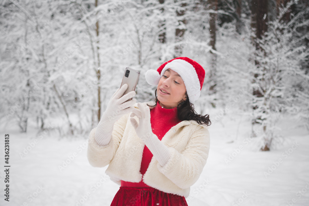 Beautiful girl in winter snowy forest in christmas clothes Beautiful girl in winter snowy forest in christmas clothes