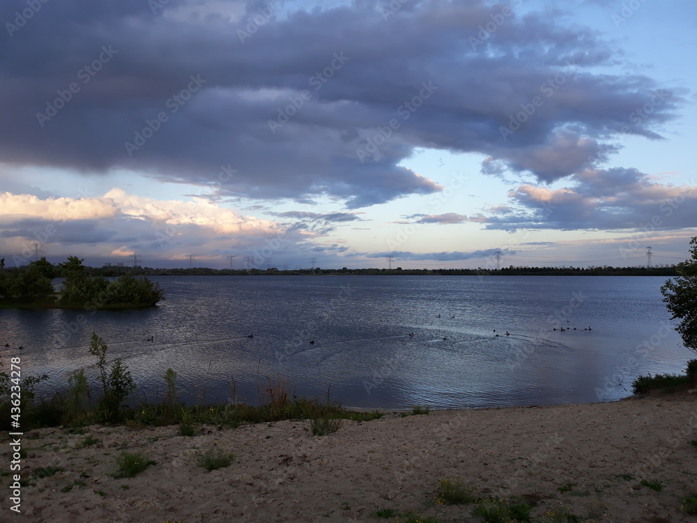 sunset over the lake, clouds over water 