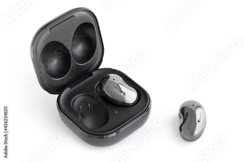 Wireless headphones in a case on white background