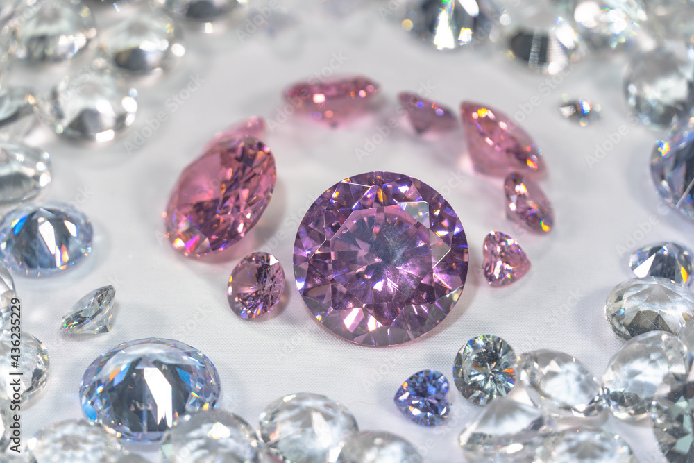 A group of pink diamonds arranged in the middle of white diamonds in a white background..Top view of pink diamonds. white diamonds background A group of pink diamonds arranged in the middle of white diamonds in a white background..Top view of pink diamonds. white diamonds background