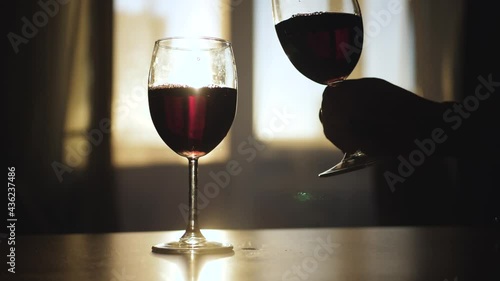 Say toast and take a glass of wine off the table.