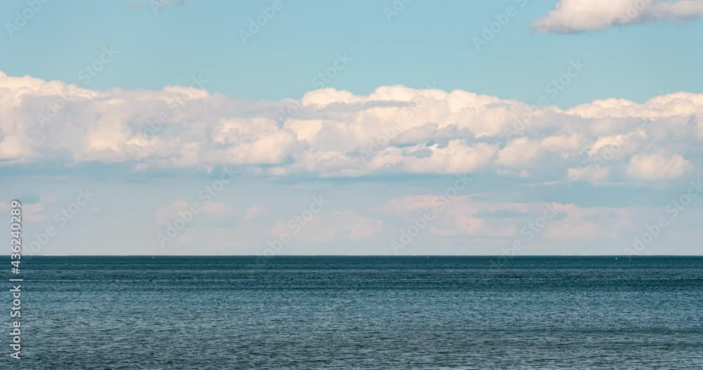 Motions time lapse clouds and water lake. White blue small clouds on the sky near water coast. Summer mood vibes b-roll. Sunny leisure cloudscape timelapse of the nature. Relaxing background. Motions time lapse clouds and water lake. White blue small clouds on the sky near water coast. Summer mood vibes b-roll. Sunny leisure cloudscape timelapse of the nature. Relaxing background.