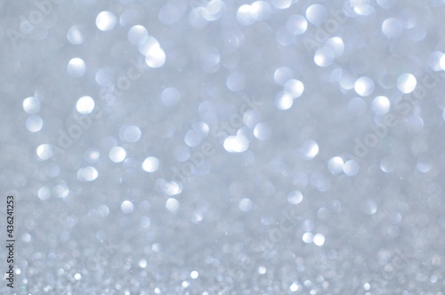 Abstract white bokeh lights glittering on blur background