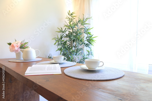 coffee and flowers on the table in a bright modern interior © Павел Ващенков