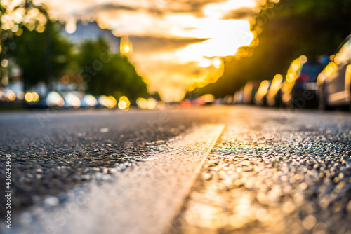 Sun after the rain in the city, view of the headlights of the approaching cars with the level dividing line