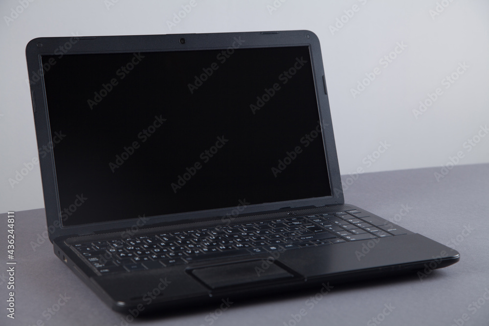 Black computer on gray table with empty screen. Black computer on gray table with empty screen.