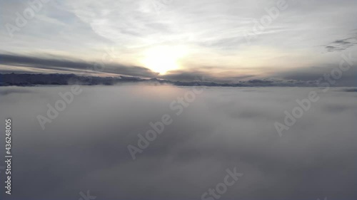Wallpaper Mural Incredible aerial view shot above swirling fog and clouds at sunset in the mountains. Flying over a low cloud surface with a ridge in the background Torontodigital.ca