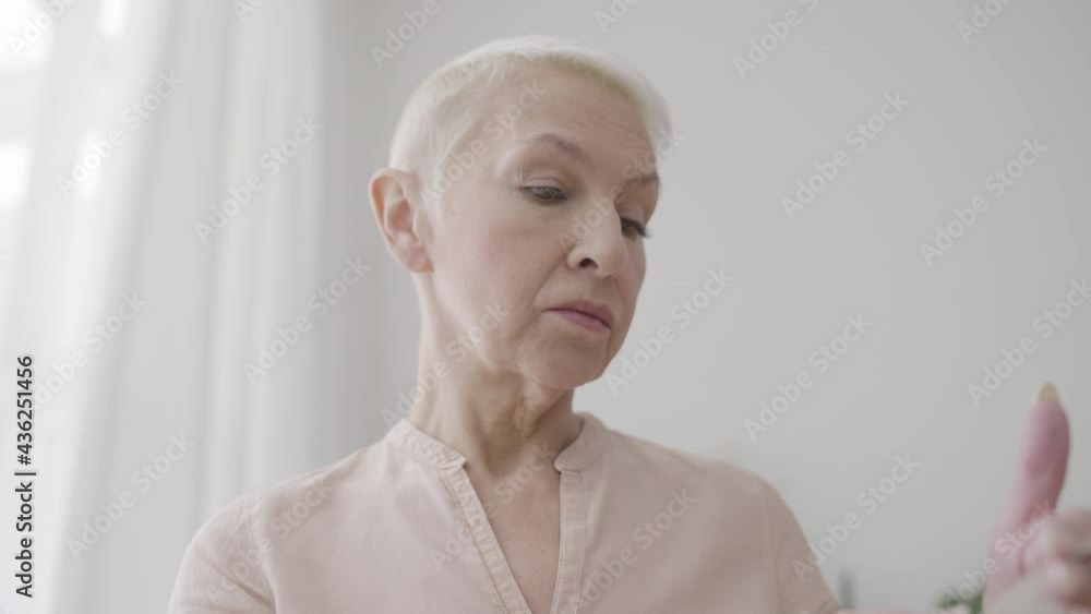Adult female checking shop receipt and grocery order in bag at home, delivery Adult female checking shop receipt and grocery order in bag at home, delivery