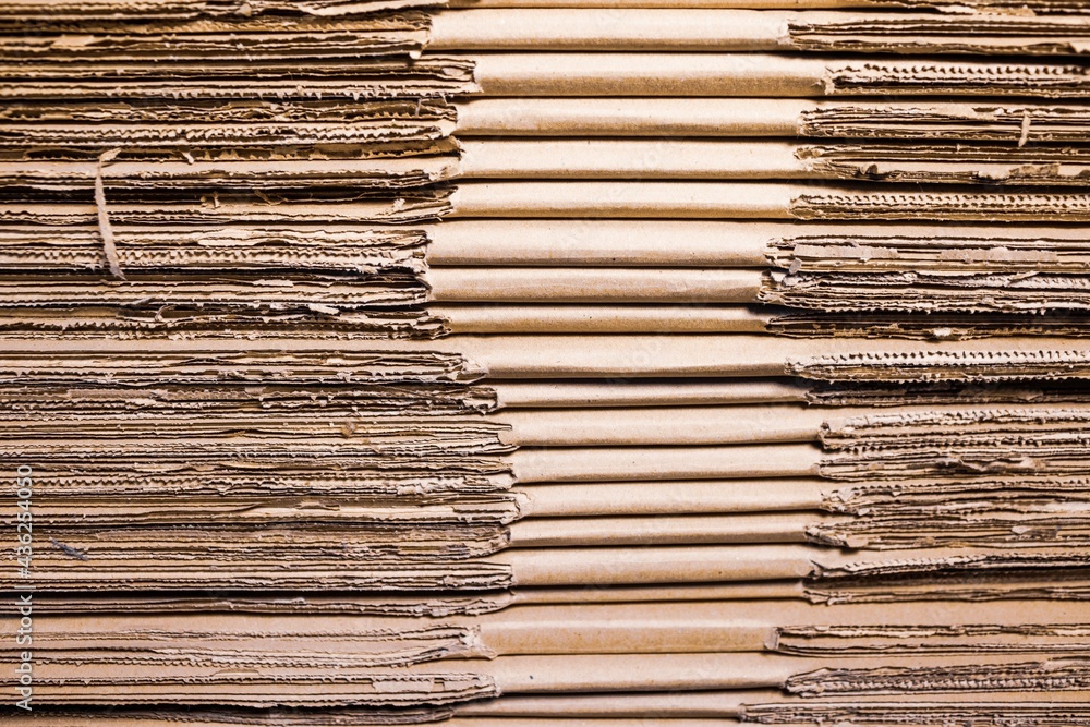 Close-up large cardboard piles lie on top Close-up large cardboard piles lie on top