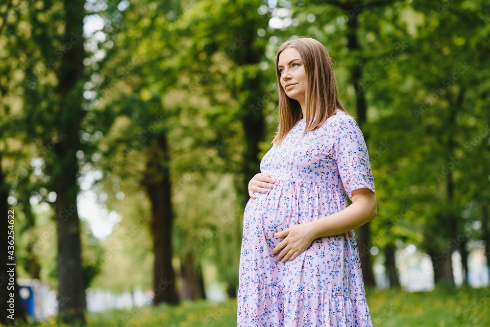 Beautiful pregnant woman relaxing in the park Beautiful pregnant woman relaxing in the park