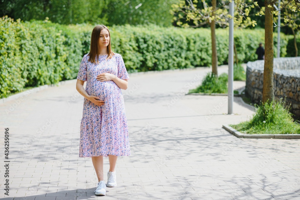 Beautiful pregnant woman relaxing in the park Beautiful pregnant woman relaxing in the park