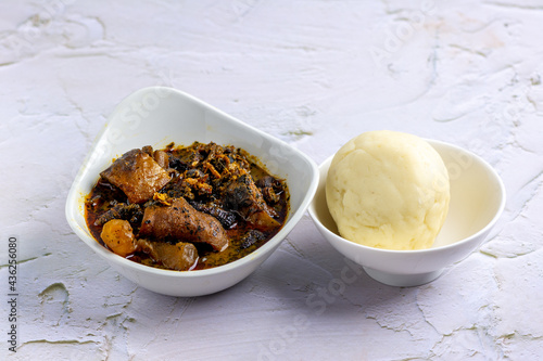 Nigerian Abak / Banga soup served with fufu / pounded yam photo