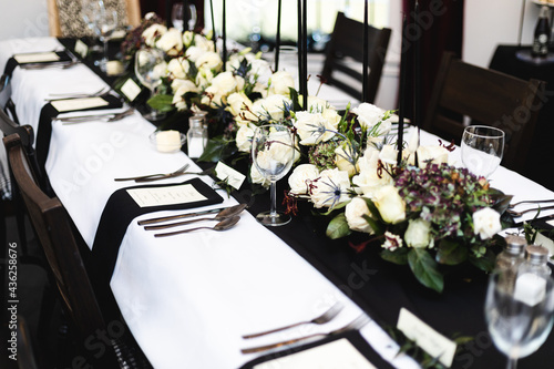 Place setup for formal black and white social dinner