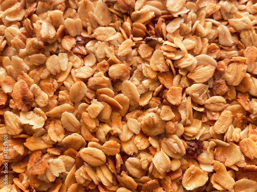 Close-up of granola, breakfast dish, snack. On the photo is a granule of oatmeal and honey. Application in the packaging of products as well as banners and articles for websites..