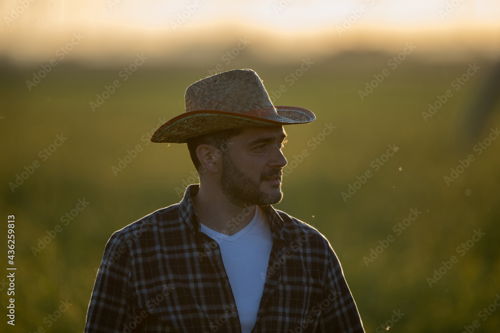 Young farmer standing in field.