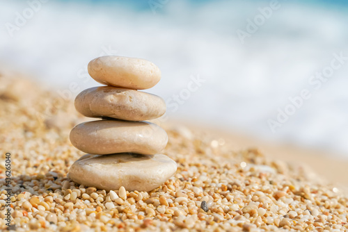 Pyramid stones balance on the sand of the beach. Zen balance  minimalism  harmony and peace. Selective focus