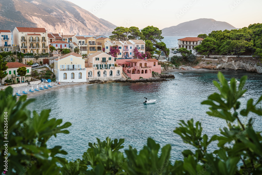 Assos on Cephalonia Ionian island in Greece. Fig leaves in foreground. Summer travel vacation Assos on Cephalonia Ionian island in Greece. Fig leaves in foreground. Summer travel vacation