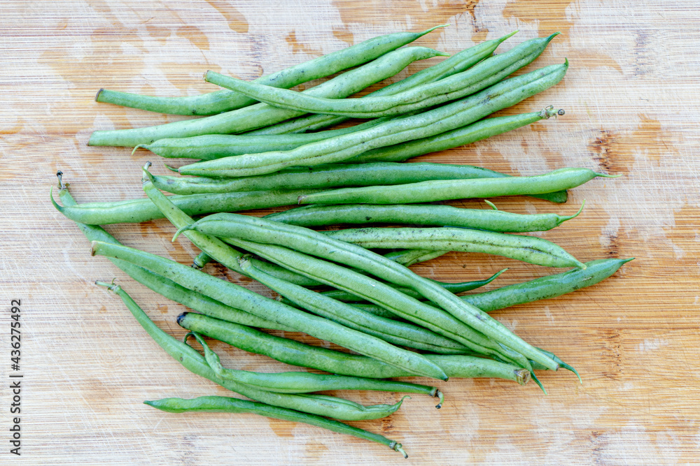 Green beans on wooden cutting board. Go green concept. Green beans on wooden cutting board. Go green concept.
