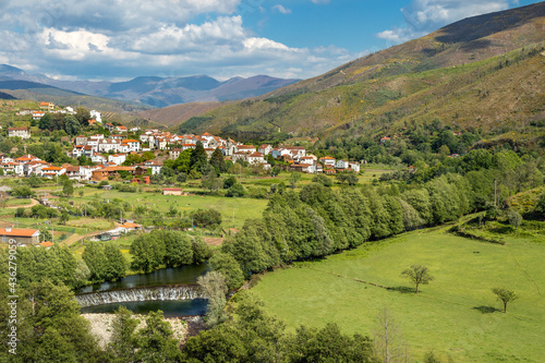 Beautiful landscape of the village of Alvoco das Várzeas in Portugal, with the Alvôco river in the foreground and the hills of Serra da Estrela in the background. photo