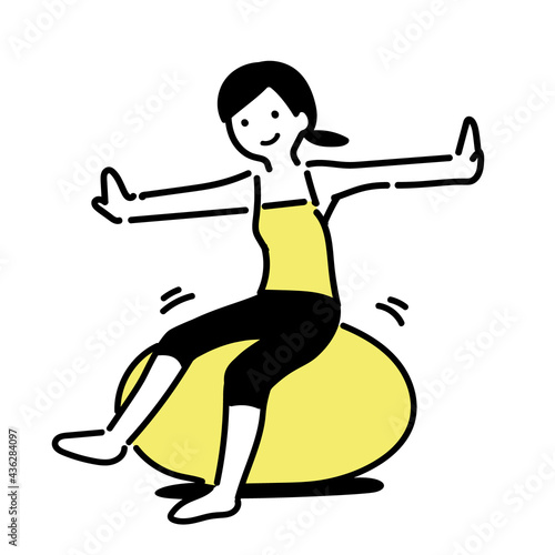 バランスボールでトレーニングをするシンプルな女性