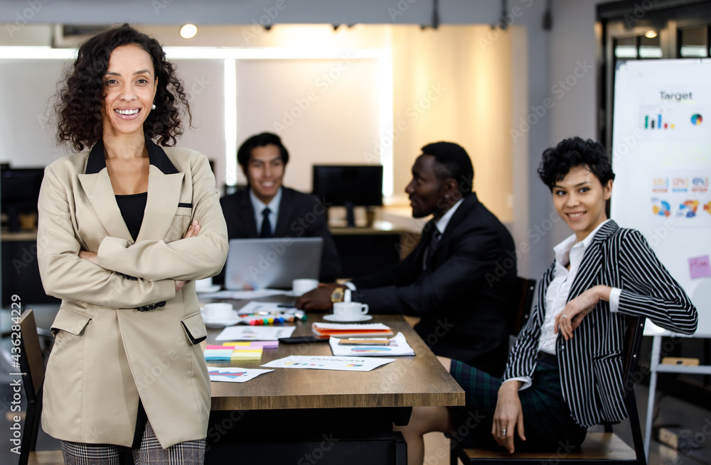 Banner African beautiful successful businesswoman manager wearing formal style clothes, happily confidently smiling, crossing arms, posing as female leader with background of employee or colleagues.