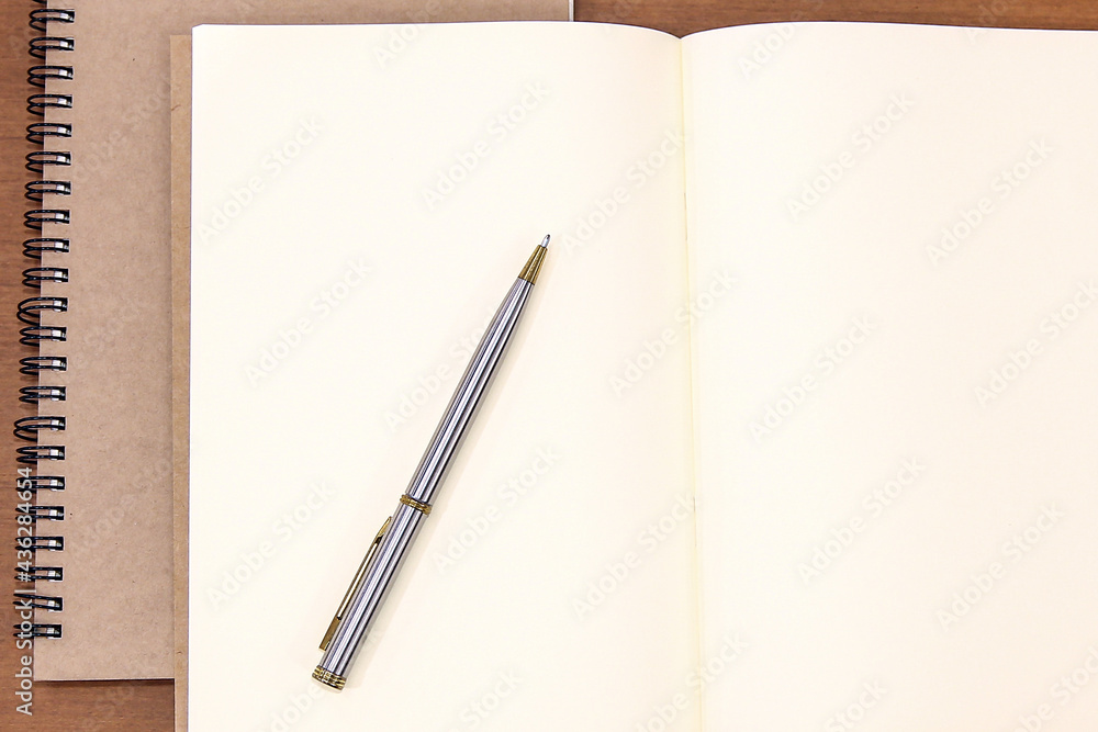 Close-up notebook or note book diary with a pen or pencil on top view desk or boardroom table for meeting notes. Close-up notebook or note book diary with a pen or pencil on top view desk or boardroom table for meeting notes.