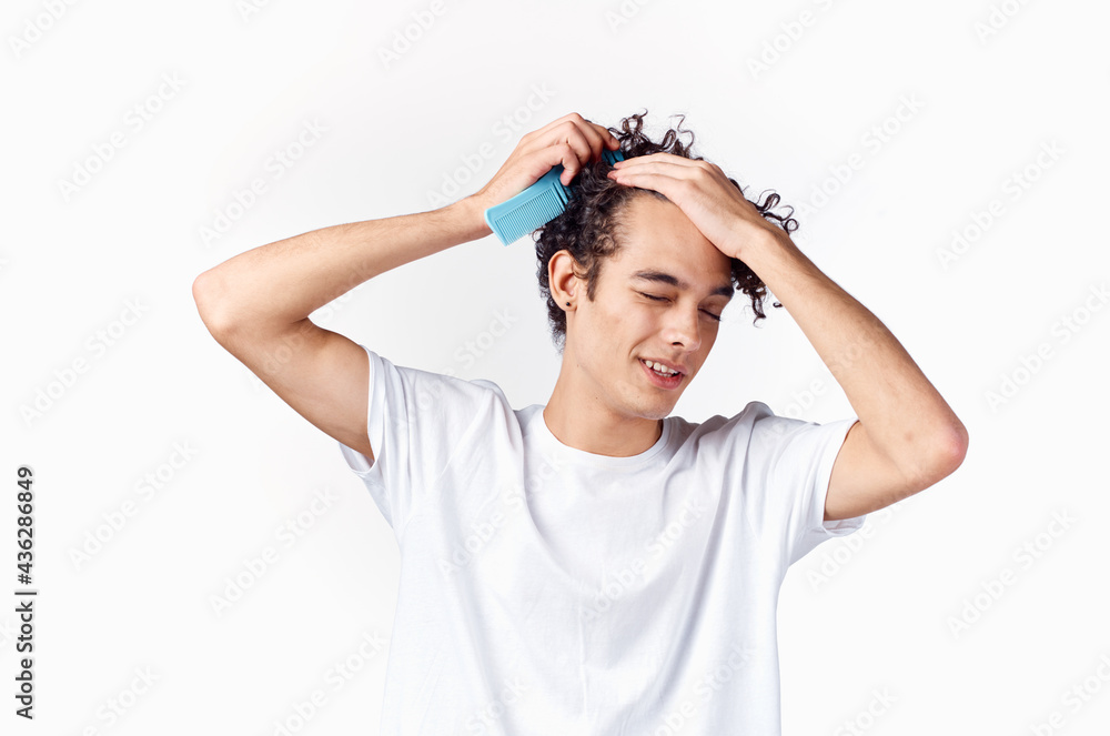 man combing curly hair dissatisfaction emotions close-up man combing curly hair dissatisfaction emotions close-up